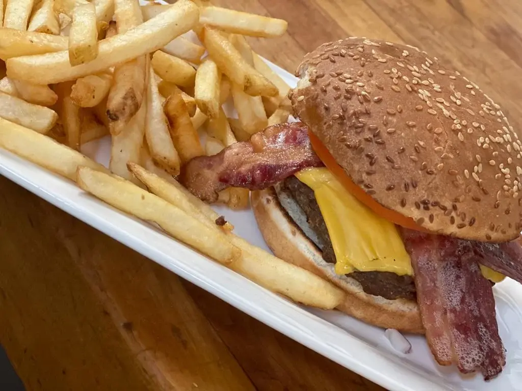 Bacon cheeseburger served with a side of fresh cut fries at DJ's Pizzeria in St. Albert, AB