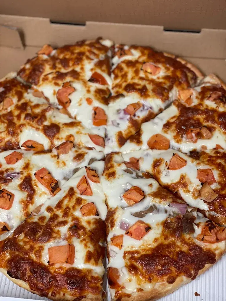 Donair pizza with donair meat, red onions and diced tomatoes in a takeout box - DJ's Pizzeria St. Albert, AB
