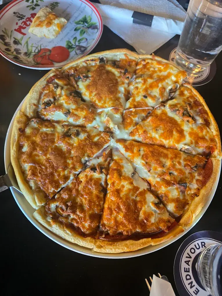Hand-tossed pepperoni and mushroom pan pizza fresh from the oven at DJ's Pizzeria St. Albert, AB