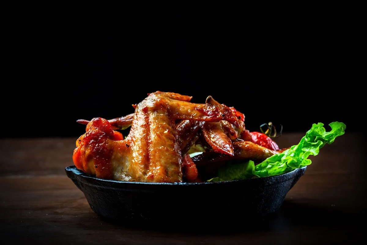 Salt and pepper chicken wings served in a cast iron skillet at DJ's Pizzeria in St. Albert, AB
